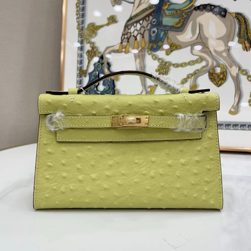 Bright Budding Lime Yellow Uniform Raised Dot Slim Horizontal Rectangular Carry Bag With Polished Golden Twist Lock Hardware And Single Short Curved Top Grip