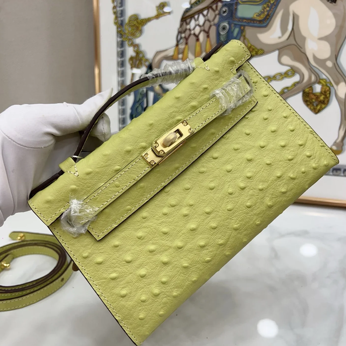 Bright Budding Lime Yellow Uniform Raised Dot Slim Horizontal Rectangular Carry Bag With Polished Golden Twist Lock Hardware And Single Short Curved Top Grip